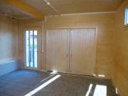 Bild 8: Hauseingang und Garage als Vorbau zum Wohnhaus bietet auch Platz für das Brennholz und die Haustechnik